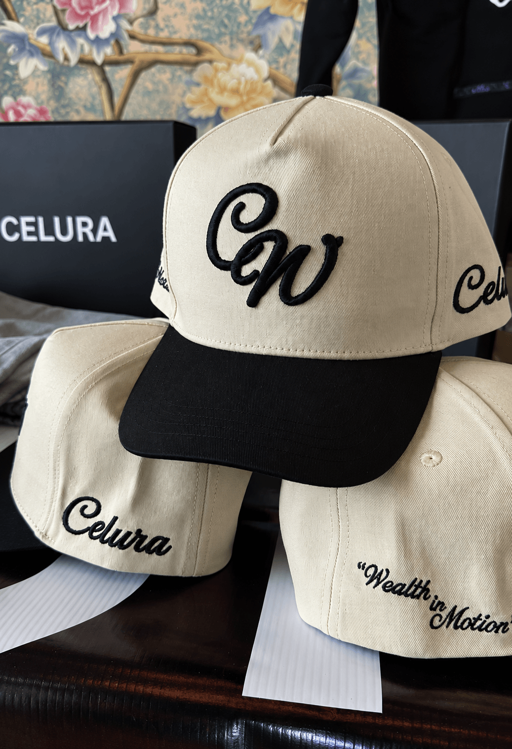 Cream and black Celura caps with embroidered logos