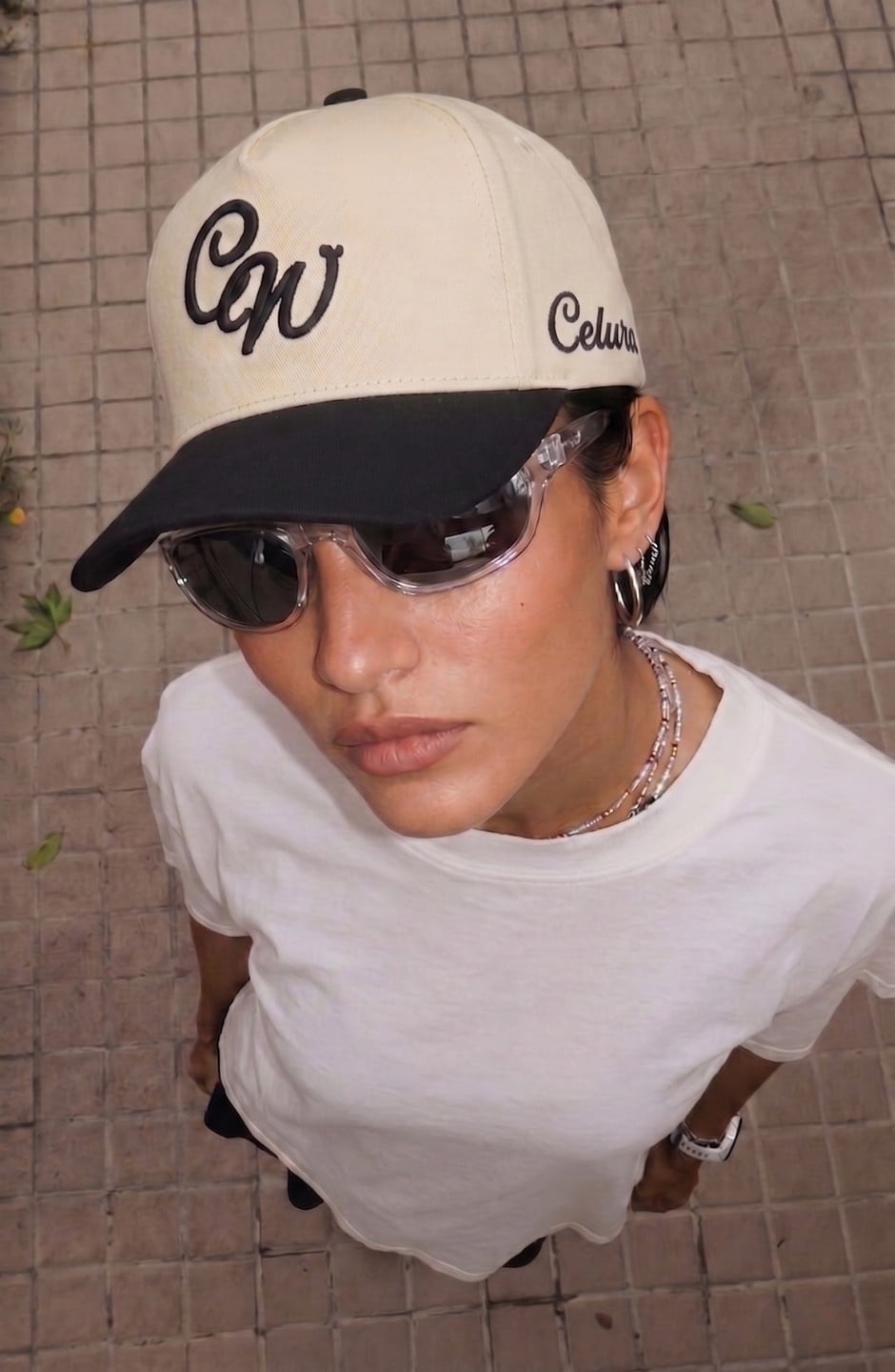 Celura cap styled with sunglasses and a white tee